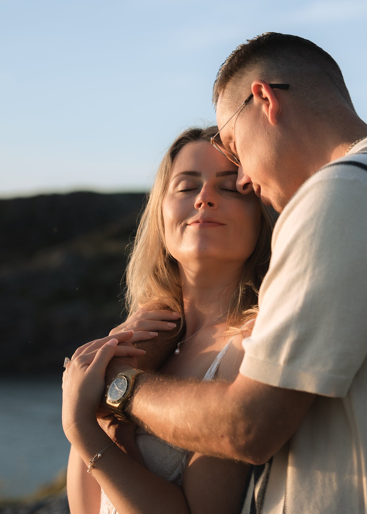 Intimate couple embracing during golden hour photography session in the Scottish Highlands.